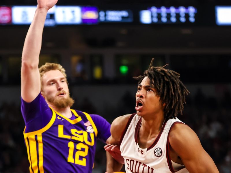 Feb 17, 2024; Columbia, South Carolina, USA; South Carolina Gamecocks forward Collin Murray-Boyles (30) drives around LSU Tigers forward Hunter Dean (12) in the first half at Colonial Life Arena. Mandatory Credit: Jeff Blake-USA TODAY Sports