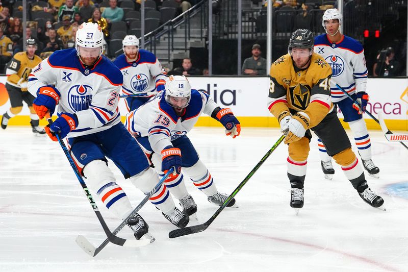 May 6, 2025; Las Vegas, Nevada, USA; Edmonton Oilers center Adam Henrique (19) and defenseman Brett Kulak (27) deflect the puck away from Vegas Golden Knights center Ivan Barbashev (49) during the second period of game one of the second round of the 2025 Stanley Cup Playoffs at T-Mobile Arena. Mandatory Credit: Stephen R. Sylvanie-Imagn Images