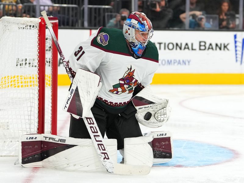 Oct 4, 2022; Las Vegas, Nevada, USA; Arizona Coyotes goaltender Jonas Johansson (31) makes a save against the Vegas Golden Knights during a preseason game at T-Mobile Arena. Mandatory Credit: Stephen R. Sylvanie-USA TODAY Sports