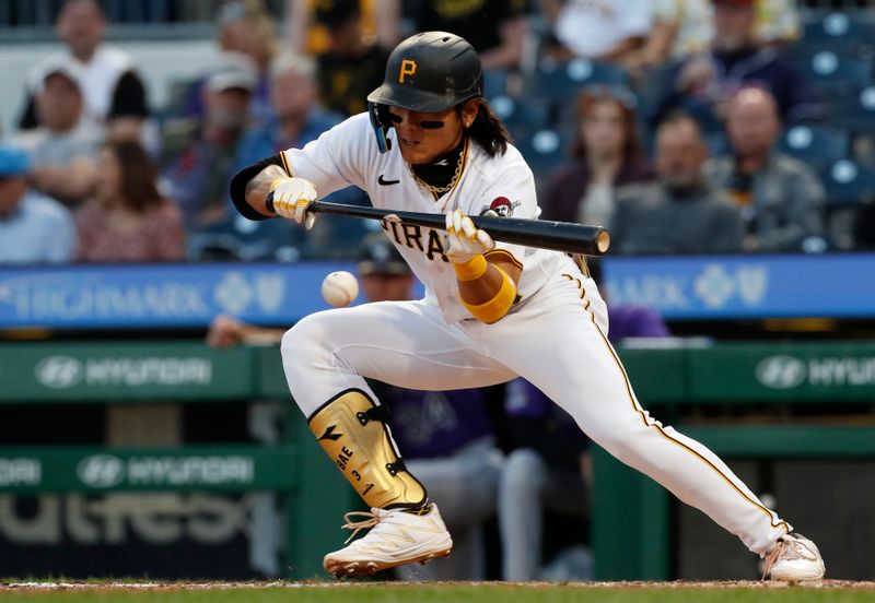 May 9, 2023; Pittsburgh, Pennsylvania, USA;  Pittsburgh Pirates second baseman Ji Hwan Bae (3) hits a sacrifice bunt against the Colorado Rockies during the fifth inning at PNC Park. Mandatory Credit: Charles LeClaire-USA TODAY Sports