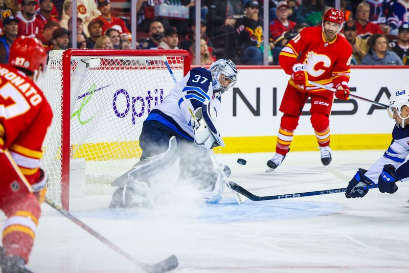 Oct 11, 2023; Calgary, Alberta, CAN; Winnipeg Jets goaltender Connor Hellebuyck (37) makes a save against the Calgary Flames during the second period at Scotiabank Saddledome. Mandatory Credit: Sergei Belski-USA TODAY Sports