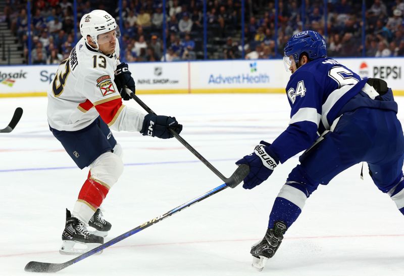 Oct 5, 2023; Tampa, Florida, USA; Florida Panthers center Sam Reinhart (13) shoot against the Tampa Bay Lightning during the first period at Amalie Arena. Mandatory Credit: Kim Klement Neitzel-USA TODAY Sports