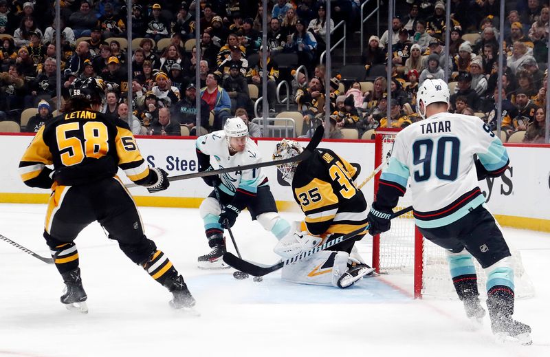 Jan 15, 2024; Pittsburgh, Pennsylvania, USA; Pittsburgh Penguins goaltender Tristan Jarry (35) makes a save against Seattle Kraken center Jaden Schwartz (17) during the second period at PPG Paints Arena. Mandatory Credit: Charles LeClaire-USA TODAY Sports