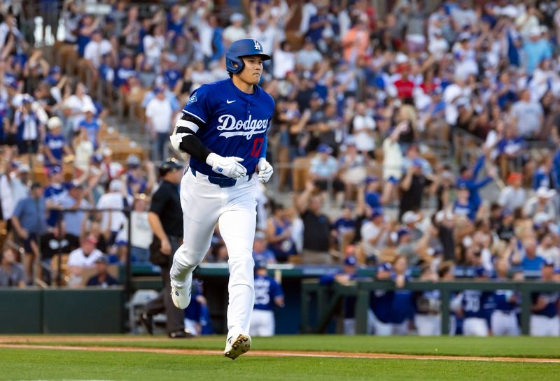 Feb 28, 2025; Phoenix, Arizona, USA; Los Angeles Dodgers designated hitter Shohei Ohtani (17) rounds the bases after hitting a leadoff home run against the Los Angeles Angels during a spring training game at Camelback Ranch-Glendale. Mandatory Credit: Mark J. Rebilas-Imagn Images