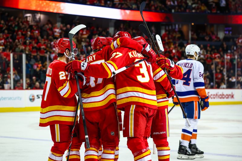 Jan 17, 2026; Calgary, Alberta, CAN; Calgary Flames defenseman Yan Kuznetsov (37) celebrates his goal with teammates against the New York Islanders during the second period at Scotiabank Saddledome. Mandatory Credit: Sergei Belski-Imagn Images
