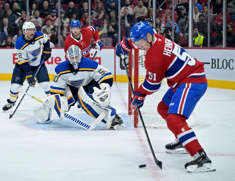 Oct 26, 2024; Montreal, Quebec, CAN; St.Louis Blues goalie Jordan Binnington (50) tracks Montreal Canadiens forward Emil Heineman (51) with the puck during the first period at the Bell Centre. Mandatory Credit: Eric Bolte-Imagn Images