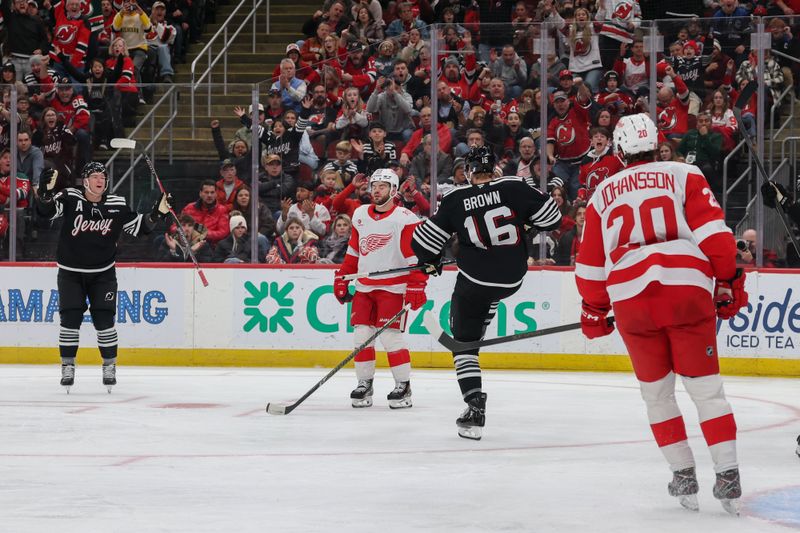Nov 24, 2025; Newark, New Jersey, USA; New Jersey Devils right wing Connor Brown (16) celebrates scoring a  goal against the Detroit Red Wings during the second period at Prudential Center. Mandatory Credit: Ed Mulholland-Imagn Images