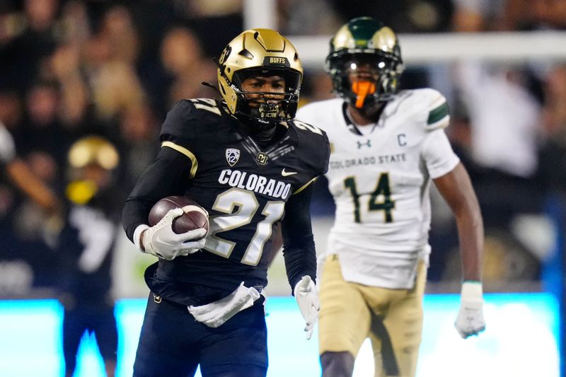 Sep 16, 2023; Boulder, Colorado, USA; Colorado Buffaloes safety Shilo Sanders (21) runs for a touchdown after making an interception against the Colorado State Rams during the first half at Folsom Field. Mandatory Credit: Ron Chenoy-USA TODAY Sports