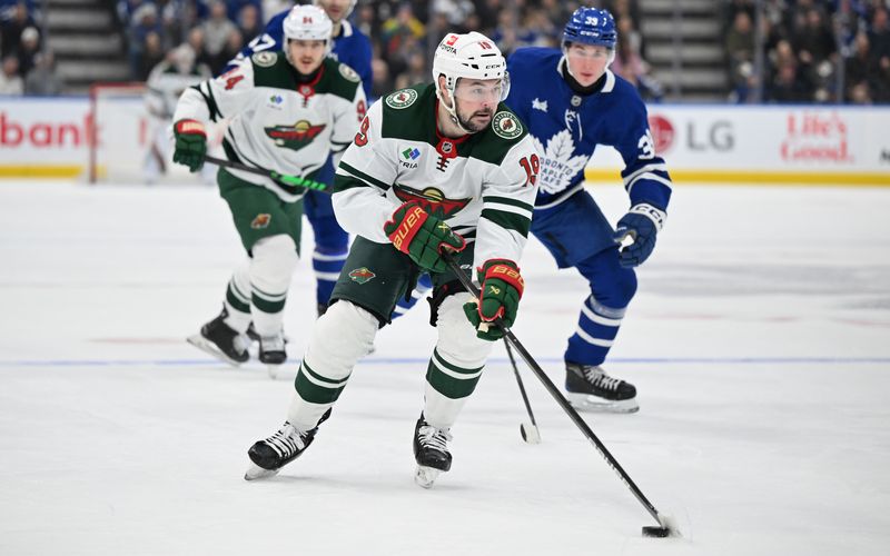 Jan 29, 2025; Toronto, Ontario, CAN; Minnesota Wild forward Devin Shore (19) leads an attack against the Toronto Maple Leafs goal in the second period at Scotiabank Arena. Mandatory Credit: Dan Hamilton-Imagn Images