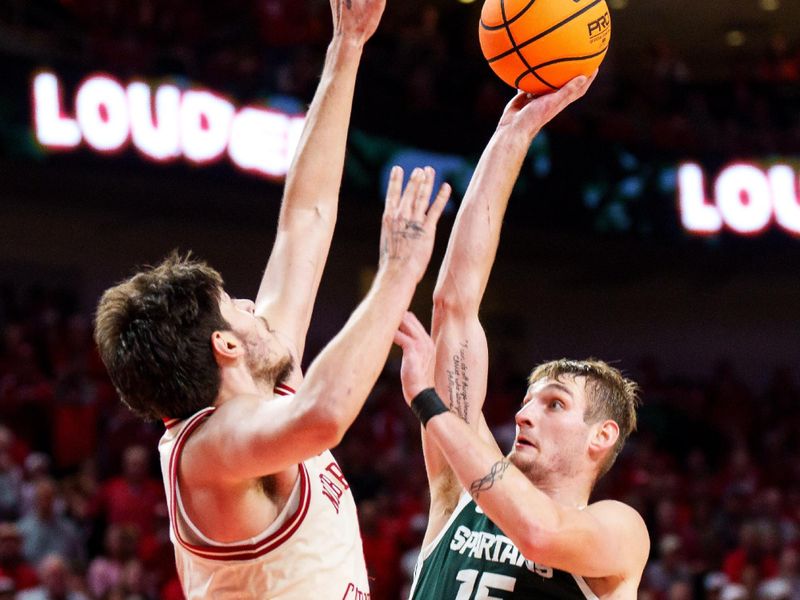 Jan 2, 2026; Lincoln, Nebraska, USA; Michigan State Spartans center Carson Cooper (15) shoots the ball against forward Berke Buyuktuncel (9) during the second half at Pinnacle Bank Arena. Mandatory Credit: Dylan Widger-Imagn Images
