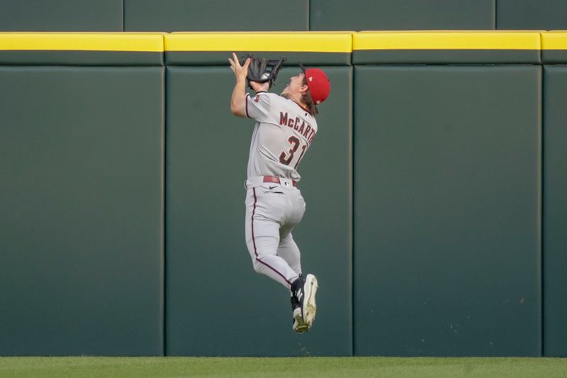 Jun 9, 2023; Detroit, Michigan, USA; Arizona Diamondbacks center fielder Jake McCarthy (31) catches a fly ball near the wall at Comerica Park during the game against the Detroit Tigers. Mandatory Credit: Brian Bradshaw Sevald-USA TODAY Sports