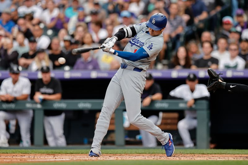 Jun 18, 2024; Denver, Colorado, USA; Los Angeles Dodgers designated hitter Shohei Ohtani (17) hits a sacrifice fielders choice RBI in the third inning against the Colorado Rockies at Coors Field. Mandatory Credit: Isaiah J. Downing-USA TODAY Sports