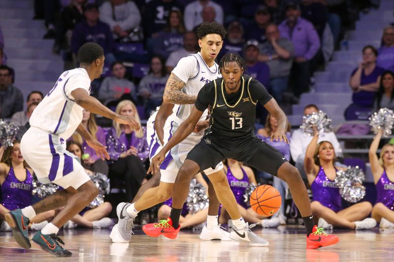 Jan 6, 2024; Manhattan, Kansas, USA; UCF Knights forward Marchelus Avery (13) tries to keep the ball from Kansas State Wildcats guard Dorian Finister (3) and guard Cam Carter (5) during the first half at Bramlage Coliseum. Mandatory Credit: Scott Sewell-USA TODAY Sports