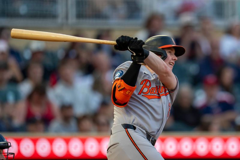 May 7, 2025; Minneapolis, Minnesota, USA; Baltimore Orioles right fielder Heston Kjerstad (13) hits a RBI single against the Minnesota Twins in the fifth inning at Target Field. Mandatory Credit: Jesse Johnson-Imagn Images