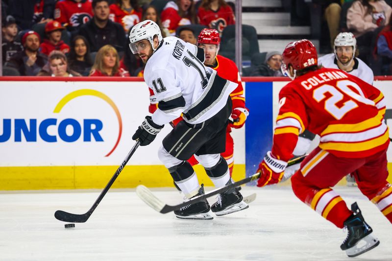 Mar 24, 2026; Calgary, Alberta, CAN; Los Angeles Kings center Anze Kopitar (11) controls the puck against the Calgary Flames during the first period at Scotiabank Saddledome. Mandatory Credit: Sergei Belski-Imagn Images