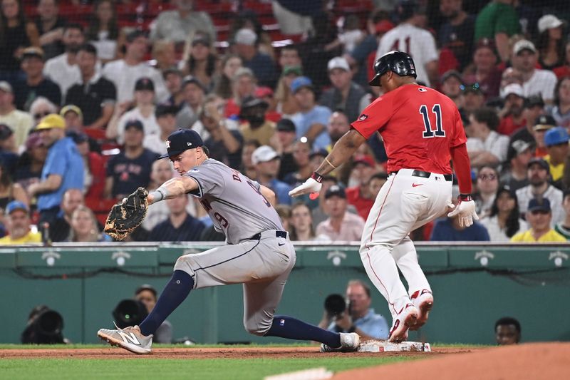 Aug 9, 2024; Boston, Massachusetts, USA; Houston Astros first baseman Zach Dezenzo (9) makes a catch against Boston Red Sox third baseman Rafael Devers (11) during the fifth inning at Fenway Park. Mandatory Credit: Eric Canha-USA TODAY Sports