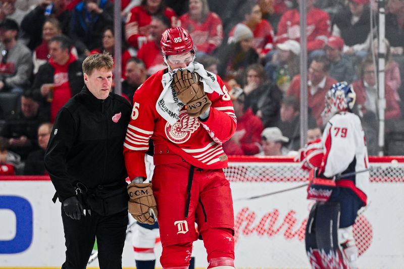 Dec 21, 2025; Detroit, Michigan, USA; Detroit Red Wings left wing Elmer Soderblom (85) is helped off the ice after being injured during the first period against the Washington Capitals at Little Caesars Arena. Mandatory Credit: Tim Fuller-Imagn Images