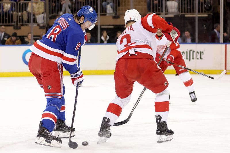 Nov 29, 2023; New York, New York, USA; New York Rangers defenseman Jacob Trouba (8) plays the puck against Detroit Red Wings defenseman Olli Maatta (2) during the first period at Madison Square Garden. Mandatory Credit: Brad Penner-USA TODAY Sports