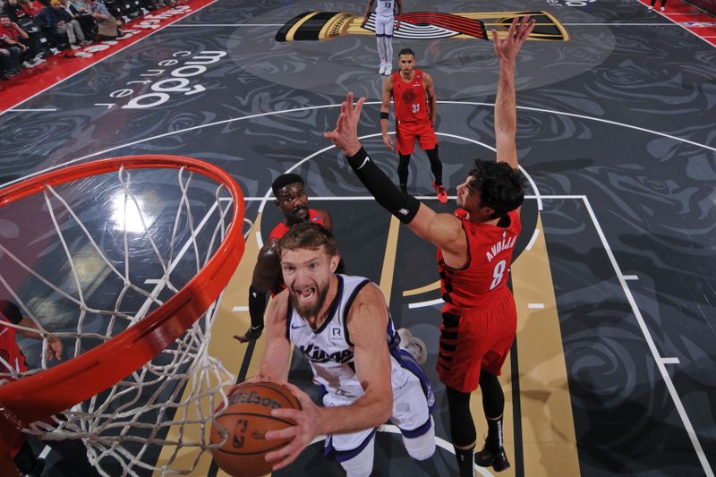 PORTLAND, OR - NOVEMBER 29: Domantas Sabonis #11 of the Sacramento Kings drives to the basket during the game against the Portland Trail Blazers during the Emirates NBA Cup on November 29, 2024 at the Moda Center Arena in Portland, Oregon. NOTE TO USER: User expressly acknowledges and agrees that, by downloading and or using this photograph, user is consenting to the terms and conditions of the Getty Images License Agreement. Mandatory Copyright Notice: Copyright 2024 NBAE (Photo by Cameron Browne/NBAE via Getty Images)