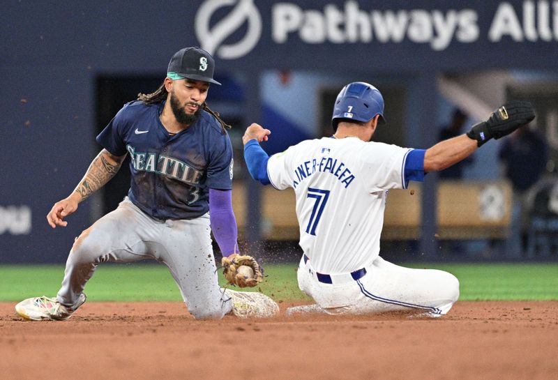 Apr 8, 2024; Toronto, Ontario, CAN;  Toronto Blue Jays third baseman Isiah Kiner-Falefa (7) steals second base ahead of a tag from Seattle Mariners shortstop J.P. Crawford (3) in the eighth inning at Rogers Centre. Mandatory Credit: Dan Hamilton-USA TODAY Sports