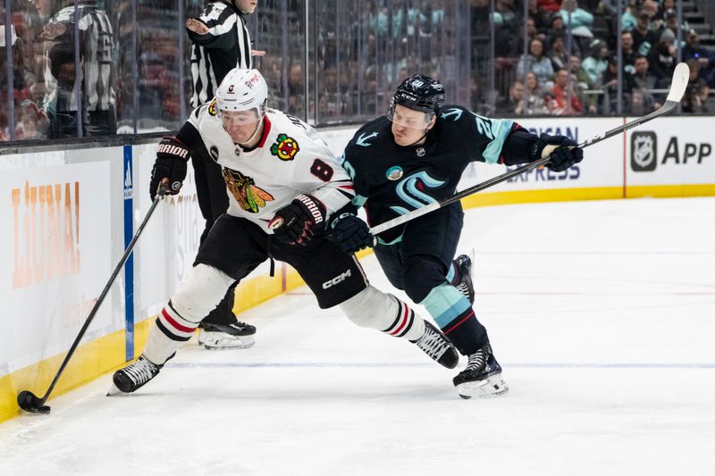 Jan 24, 2024; Seattle, Washington, USA; Chicago Blackhawks forward Ryan Donato (8) battles Seattle Kraken defenseman Vince Dunn (29) for the puck during the second period at Climate Pledge Arena. Mandatory Credit: Stephen Brashear-USA TODAY Sports