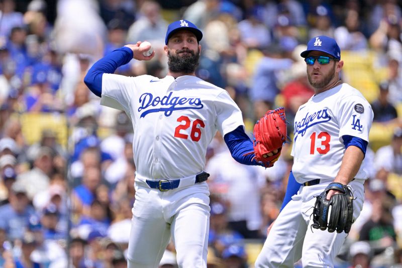 Apr 30, 2025; Los Angeles, California, USA; Los Angeles Dodgers starting pitcher Tony Gonsolin (26) throws out Miami Marlins shortstop Xavier Edwards (9) at first base after a bunt during the third inning at Dodger Stadium. Mandatory Credit: Jayne Kamin-Oncea-Imagn Images