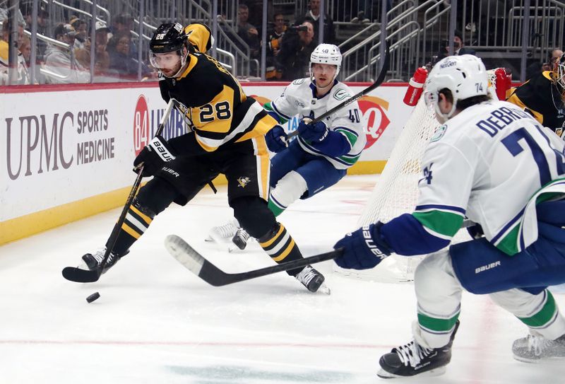 Nov 27, 2024; Pittsburgh, Pennsylvania, USA;  Pittsburgh Penguins defenseman Marcus Pettersson (28) moves the puck against Vancouver Canucks center Elias Pettersson (40) and Vancouver Canucks left wing Jake DeBrusk (74) during the second period at PPG Paints Arena. Mandatory Credit: Charles LeClaire-Imagn Images
