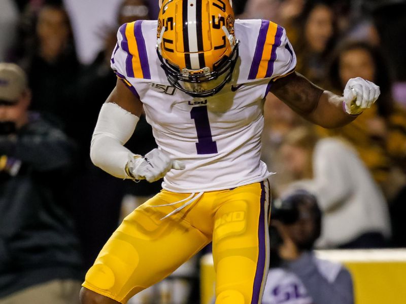 Nov 23, 2019; Baton Rouge, LA, USA; LSU Tigers wide receiver Ja'Marr Chase (1) celebrates after scoring a touchdown against Arkansas Razorbacks during the first half at Tiger Stadium. Mandatory Credit: Stephen Lew-USA TODAY Sports