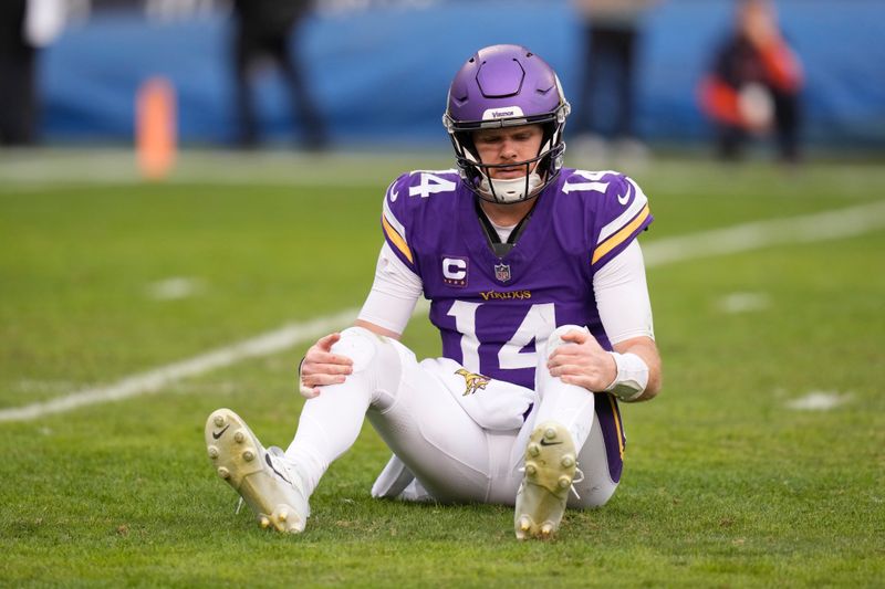 Minnesota Vikings quarterback Sam Darnold (14) goes with an injury during the second half of an NFL football game against the Chicago Bears, Sunday, Nov. 24, 2024, in Chicago. (AP Photo/Erin Hooley)