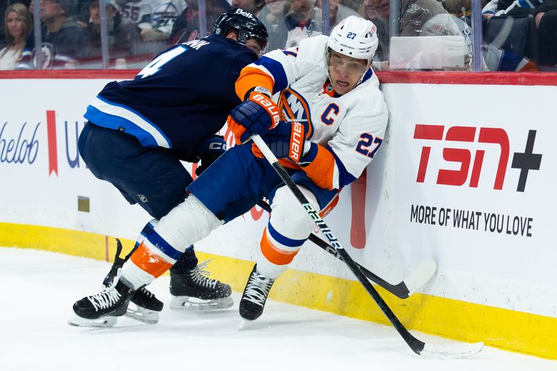 Jan 16, 2024; Winnipeg, Manitoba, CAN; New York Islanders forward Anders Lee (27) skates away from Winnipeg Jets defenseman Neal Pionk (4) during the first period at Canada Life Centre. Mandatory Credit: Terrence Lee-USA TODAY Sports