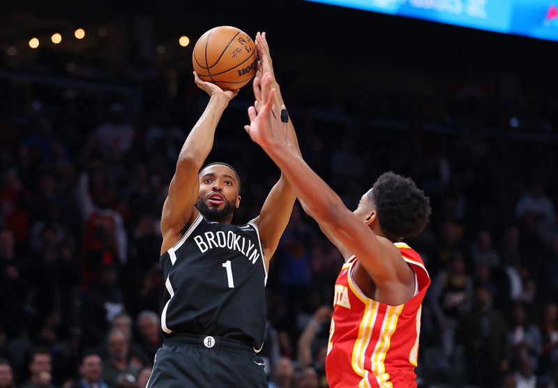 ATLANTA, GEORGIA - DECEMBER 06:  Mikal Bridges #1 of the Brooklyn Nets hits what ends up being the game-winning basket against De'Andre Hunter #12 of the Atlanta Hawks in the final seconds of their 114-113 at State Farm Arena on December 06, 2023 in Atlanta, Georgia.  NOTE TO USER: User expressly acknowledges and agrees that, by downloading and/or using this photograph, user is consenting to the terms and conditions of the Getty Images License Agreement.  (Photo by Kevin C. Cox/Getty Images)