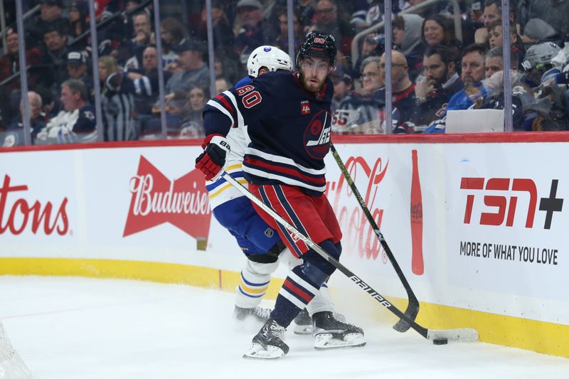 Jan 26, 2023; Winnipeg, Manitoba, CAN;  Winnipeg Jets forward Pierre-Luc Dubois (80) battles Buffalo Sabres defenseman Henri Jokiharju (10) along the boards during the second period at Canada Life Centre. Mandatory Credit: Terrence Lee-USA TODAY Sports