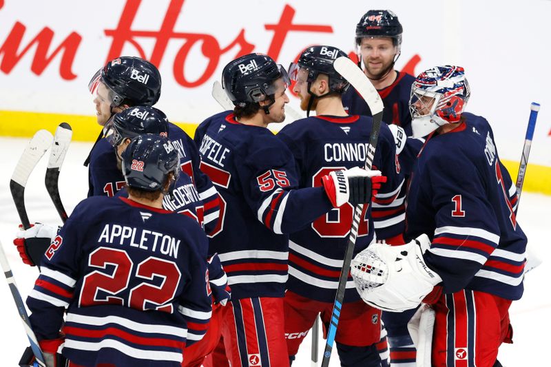 Oct 20, 2024; Winnipeg, Manitoba, CAN; Winnipeg Jets celebrate their victory over the Pittsburgh Penguins at Canada Life Centre. Mandatory Credit: James Carey Lauder-Imagn Images