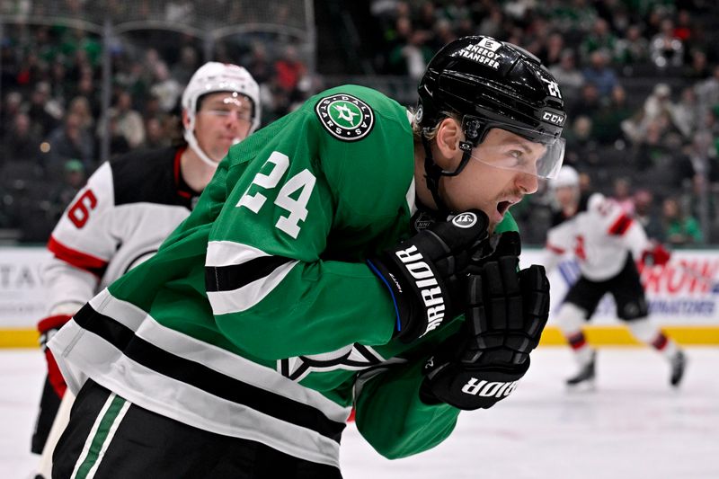 Mar 4, 2025; Dallas, Texas, USA; Dallas Stars center Roope Hintz (24) reacts to getting hit by the high stick of New Jersey Devils left wing Erik Haula (56) during the second period at the American Airlines Center. Mandatory Credit: Jerome Miron-Imagn Images