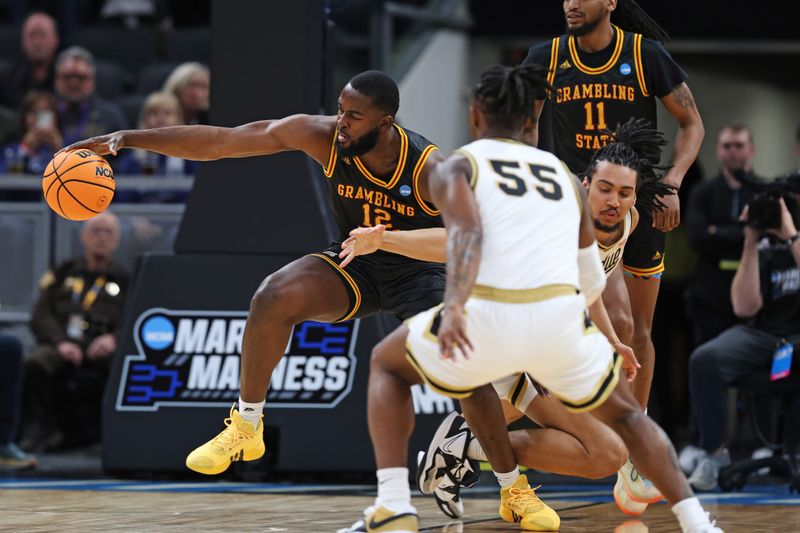 Mar 22, 2024; Indianapolis, IN, USA; Grambling State Tigers forward Jonathan Aku (12) goes for a loose ball during the first half against the Grambling State Tigers in the first round of the 2024 NCAA Tournament at Gainbridge FieldHouse. Mandatory Credit: Trevor Ruszkowski-USA TODAY Sports