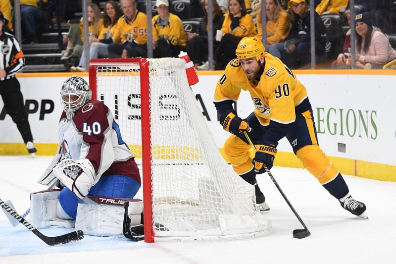 Mar 2, 2024; Nashville, Tennessee, USA; Nashville Predators center Ryan O'Reilly (90) attempts a wrap around against Colorado Avalanche goaltender Alexandar Georgiev (40) during the first period at Bridgestone Arena. Mandatory Credit: Christopher Hanewinckel-USA TODAY Sports