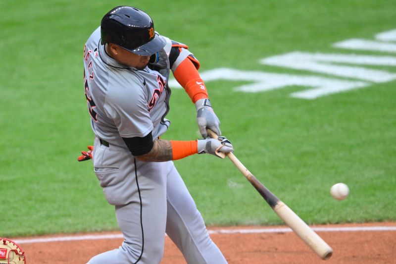 May 6, 2024; Cleveland, Ohio, USA; Detroit Tigers shortstop Javier Baez (28) singles in the fifth inning against the Cleveland Guardians at Progressive Field. Mandatory Credit: David Richard-USA TODAY Sports