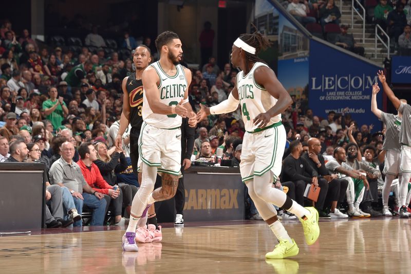 CLEVELAND, OH - MARCH 5: Jayson Tatum #0 and Jrue Holiday #4 of the Boston Celtics high five during the game against the Cleveland Cavaliers on March 5, 2024 at Rocket Mortgage FieldHouse in Cleveland, Ohio. NOTE TO USER: User expressly acknowledges and agrees that, by downloading and/or using this Photograph, user is consenting to the terms and conditions of the Getty Images License Agreement. Mandatory Copyright Notice: Copyright 2024 NBAE (Photo by David Liam Kyle/NBAE via Getty Images)