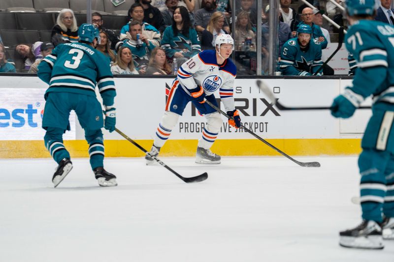 Feb 28, 2026; San Jose, California, USA; Edmonton Oilers center Trent Frederic (10) looks to pass the puck against San Jose Sharks defenseman John Klingberg (3) during the first period at SAP Center at San Jose. Mandatory Credit: Neville E. Guard-Imagn Images
