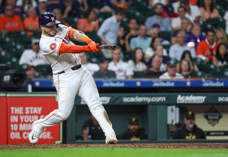 Jul 30, 2024; Houston, Texas, USA; Houston Astros catcher Yainer Diaz (21) hits a single during the eighth inning against the Pittsburgh Pirates at Minute Maid Park. Mandatory Credit: Troy Taormina-USA TODAY Sports