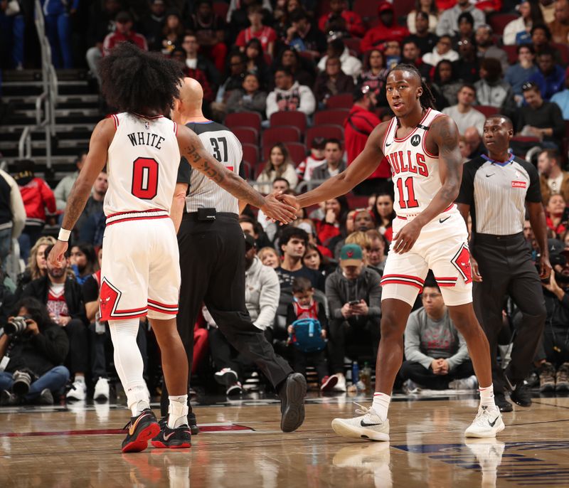 CHICAGO, IL - DECEMBER 8: Coby White #0 and Ayo Dosunmu #11 of the Chicago Bulls high five during the game against the Philadelphia 76ers on December 8, 2024 at United Center in Chicago, Illinois. NOTE TO USER: User expressly acknowledges and agrees that, by downloading and or using this photograph, User is consenting to the terms and conditions of the Getty Images License Agreement. Mandatory Copyright Notice: Copyright 2024 NBAE (Photo by Gary Dineen/NBAE via Getty Images)