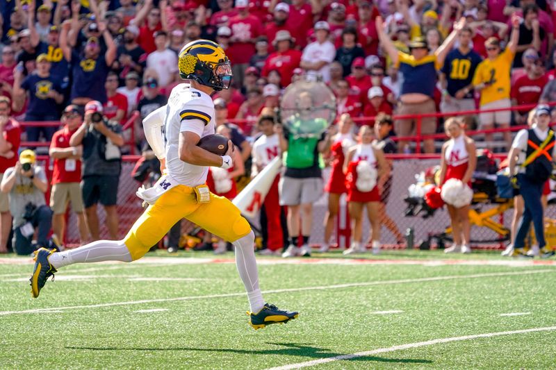 Sep 30, 2023; Lincoln, Nebraska, USA; Michigan Wolverines quarterback J.J. McCarthy (9) runs for a touchdown against the Nebraska Cornhuskers during the second quarter at Memorial Stadium. Mandatory Credit: Dylan Widger-USA TODAY Sports