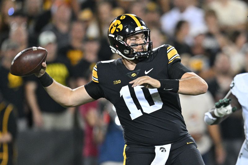 Sep 30, 2023; Iowa City, Iowa, USA; Iowa Hawkeyes quarterback Deacon Hill (10) throws a pass against the Michigan State Spartans during the second quarter at Kinnick Stadium. Mandatory Credit: Jeffrey Becker-USA TODAY Sports