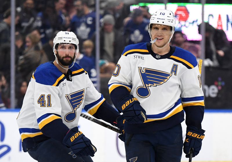 Jan 3, 2023; Toronto, Ontario, CAN;  St. Louis Blues forward Brayden Schenn (10) celebrates with defenseman Robert Bortuzzo (41) after scoring the overtime shootout winning goal against the Toronto Maple Leafs at Scotiabank Arena. Mandatory Credit: Dan Hamilton-USA TODAY Sports