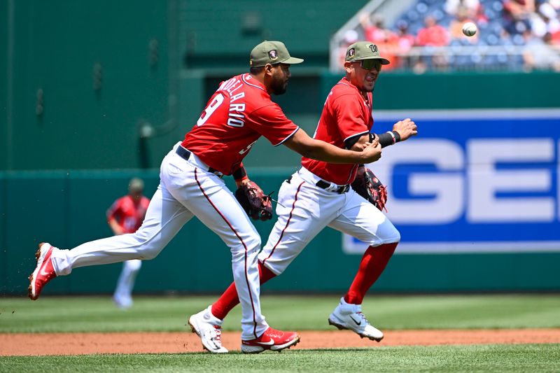 May 21, 2023; Washington, District of Columbia, USA; Washington Nationals third baseman Jeimer Candelario (9) and second baseman Ildemaro Vargas (14) race off the field after the first inning against the Detroit Tigers at Nationals Park. Mandatory Credit: Brad Mills-USA TODAY Sports