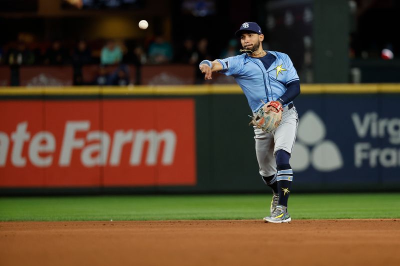 Aug 27, 2024; Seattle, Washington, USA; Tampa Bay Rays second baseman Jose Caballero (7) throws to first base for an out against the Seattle Mariners during the fifth inning at T-Mobile Park. Mandatory Credit: Joe Nicholson-USA TODAY Sports