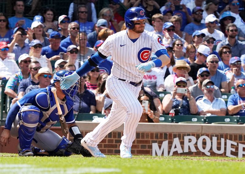 Aug 19, 2023; Chicago, Illinois, USA; Chicago Cubs left fielder Ian Happ (8) hits a one run single against the Kansas City Royals during the fourth inning at Wrigley Field. Mandatory Credit: David Banks-USA TODAY Sports