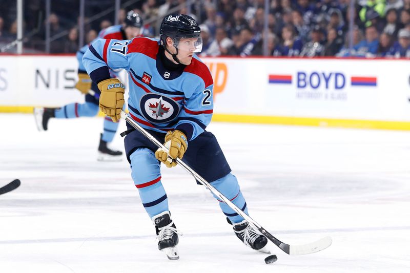 Jan 27, 2024; Winnipeg, Manitoba, CAN; Winnipeg Jets left wing Nikolaj Ehlers (27) skates with the puck in the second period against the Toronto Maple Leafs at Canada Life Centre. Mandatory Credit: James Carey Lauder-USA TODAY Sports