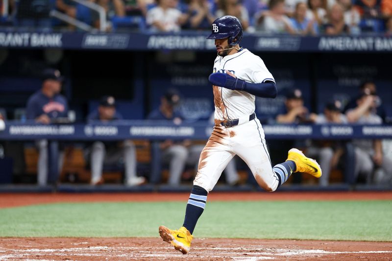 Aug 13, 2024; St. Petersburg, Florida, USA; Tampa Bay Rays shortstop Jose Caballero (7) scores a run against the Houston Astros in the second inning at Tropicana Field. Mandatory Credit: Nathan Ray Seebeck-USA TODAY Sports