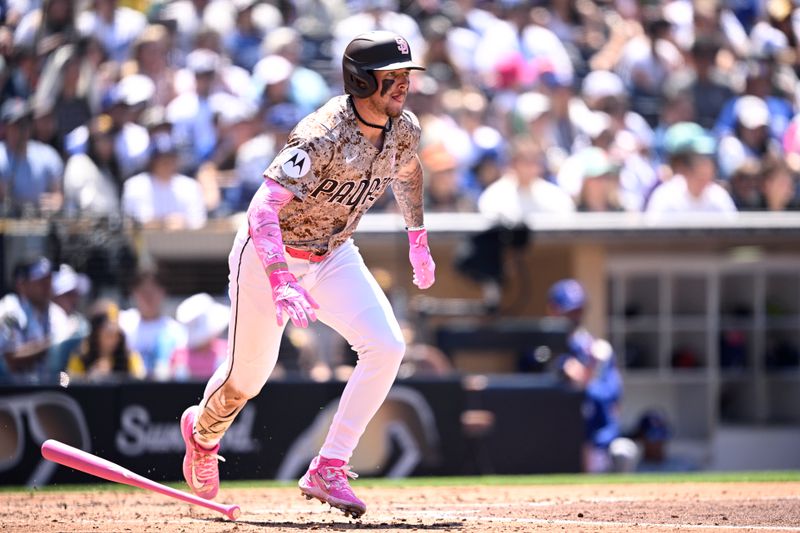 May 12, 2024; San Diego, California, USA; San Diego Padres center fielder Jackson Merrill (3) hits a single against the Los Angeles Dodgers during the fourth inning at Petco Park. Mandatory Credit: Orlando Ramirez-USA TODAY Sports